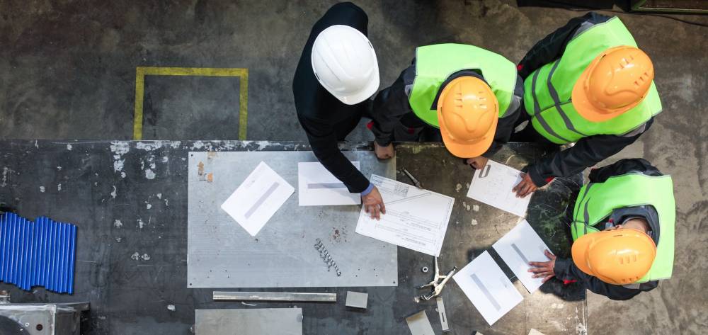 Construction workers looking at documents on a job site