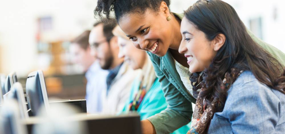 Students looking at laptops