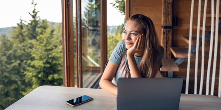 a person with a lapton looking out the window