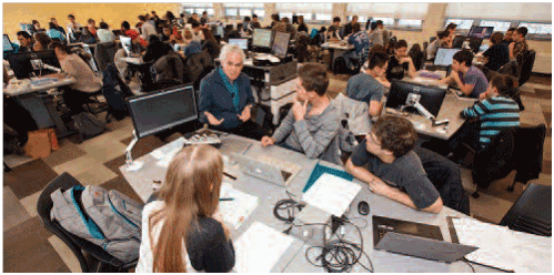 Students in groups discussing course materials