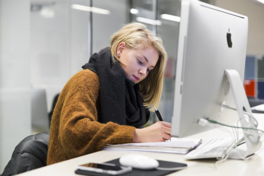 Image of a young female student writing notes