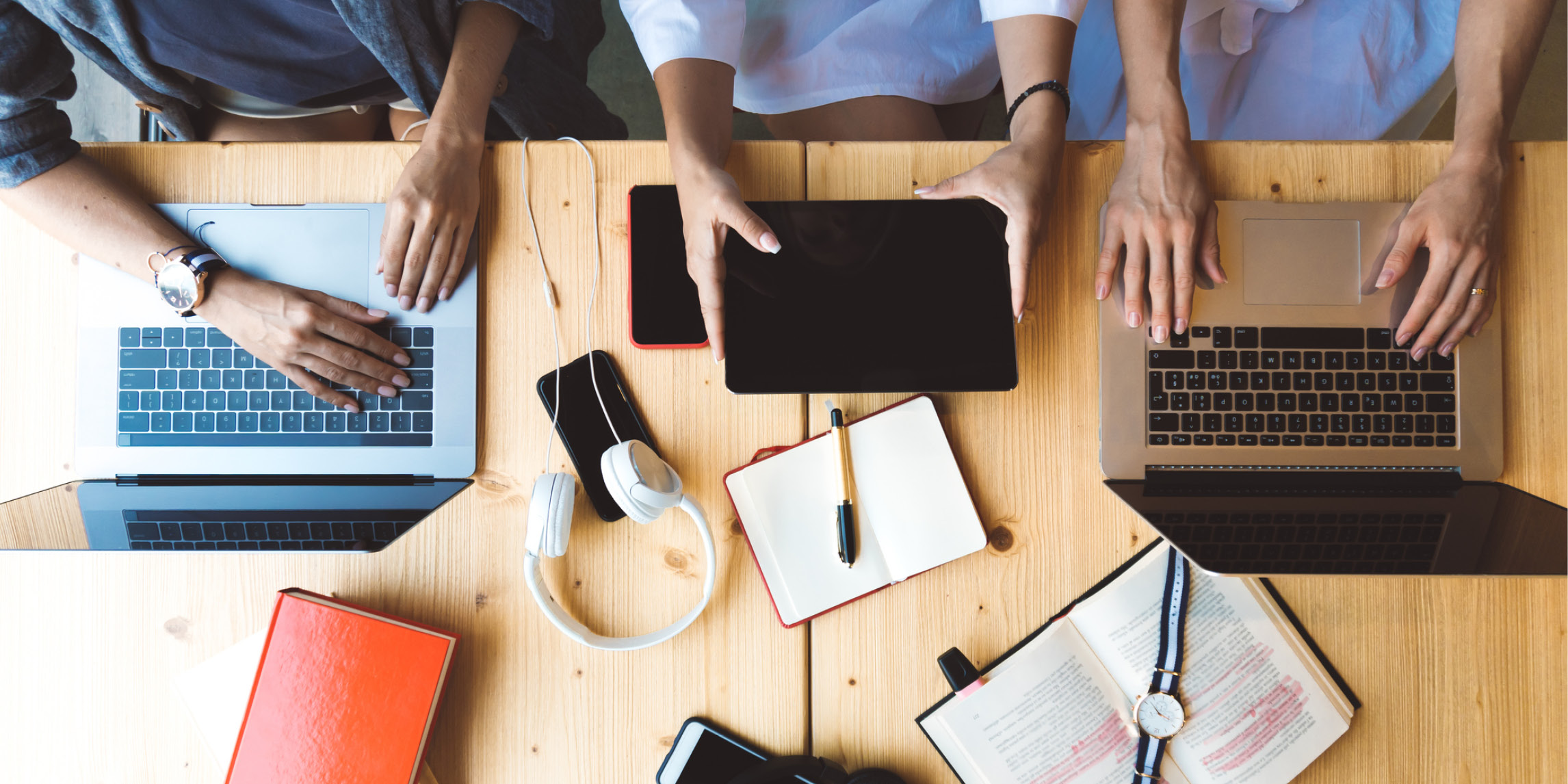 Three people on laptops and tablets