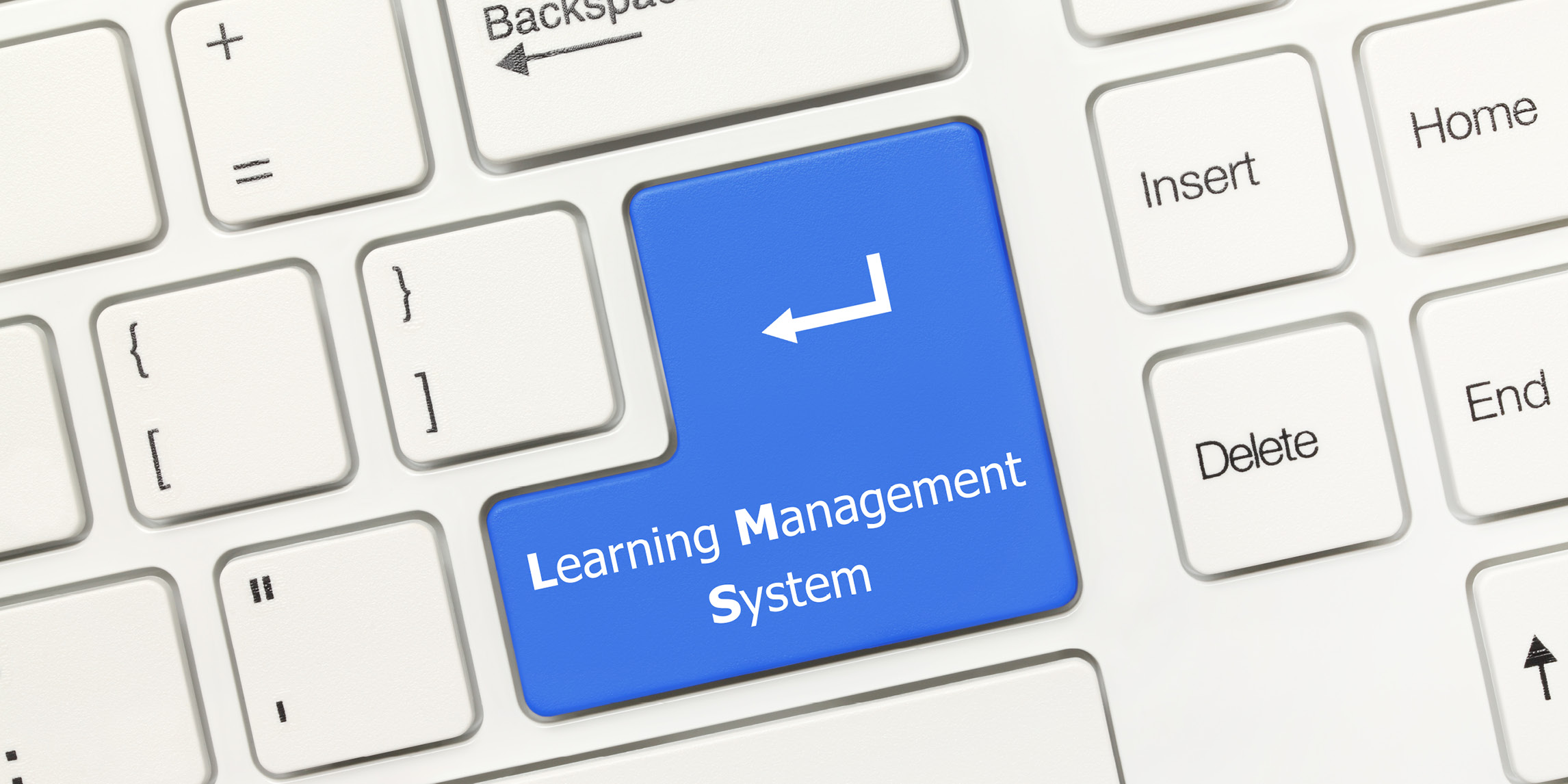 The Return key on a keyboard reading Learning Management System