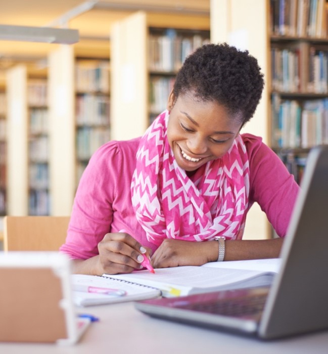 a-happy-student-doing-a-writting-project.jpg A happy student doing a writing project
