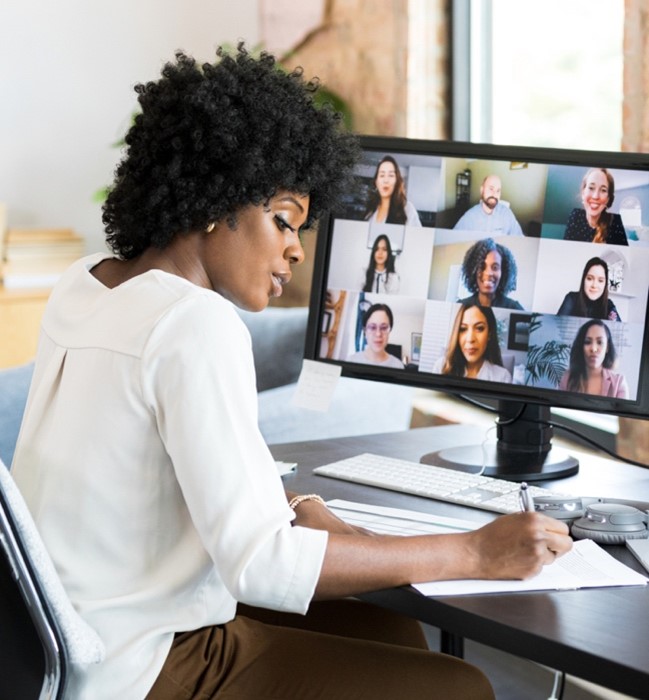 Person taking notes in an online class