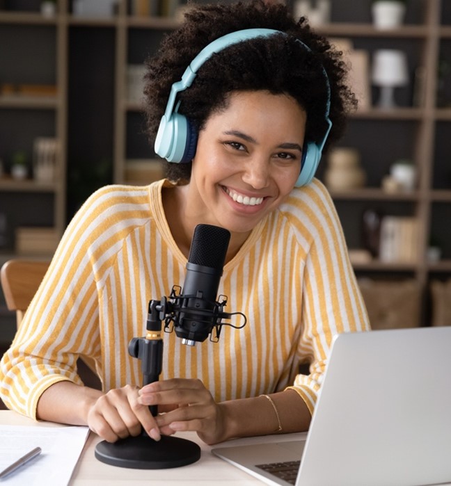 person smiling in front of a microphone
